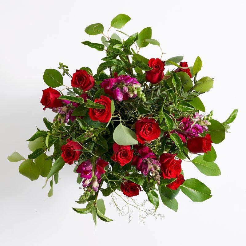 Top shot of plum red roses, maroon snapdragons and greenery| Fabulous Flowers