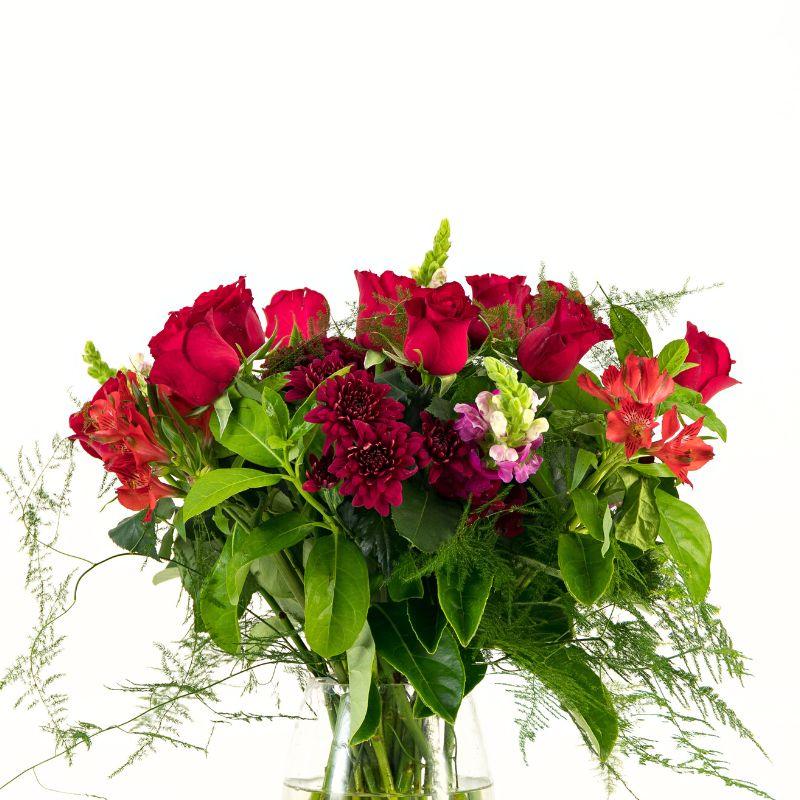Close up of red roses, chrysanthemums, snapdragons and alstroemeria for romantic gifts like Valentine's Day.