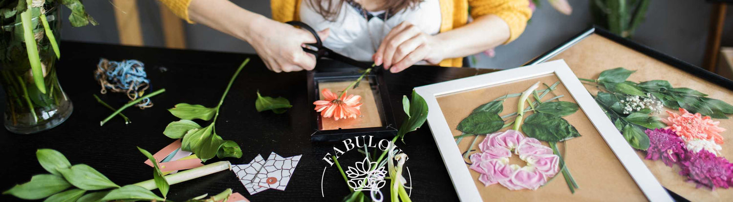 Person crafting floral art using fresh flowers, showcasing creativity and elegance with Fabulous Flowers and Gifts