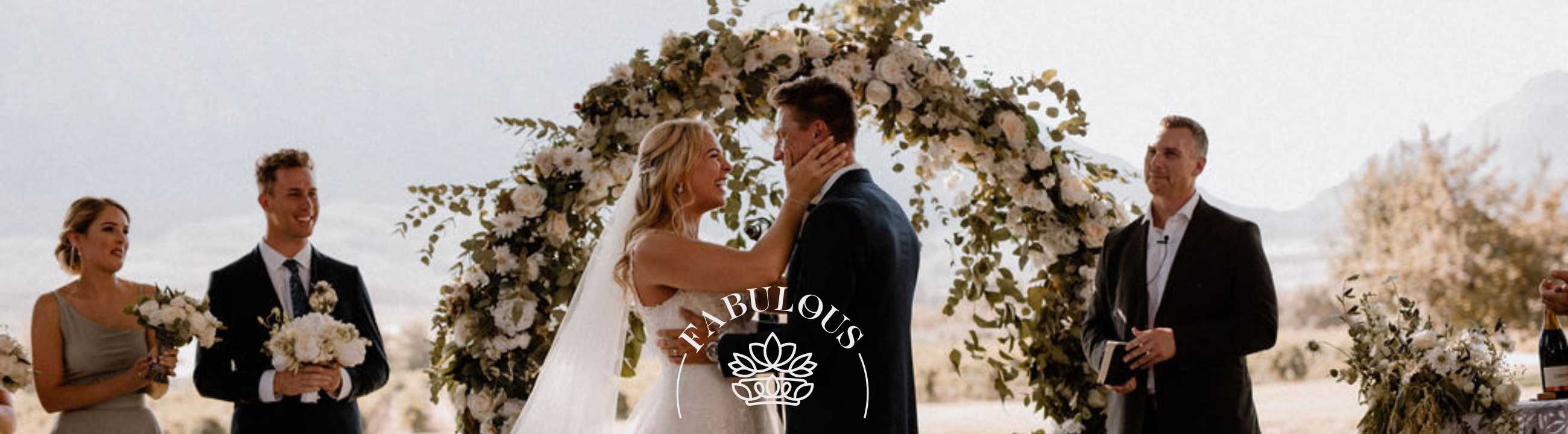 Bride and groom exchanging vows under a floral arch, Fabulous Flowers and Gifts