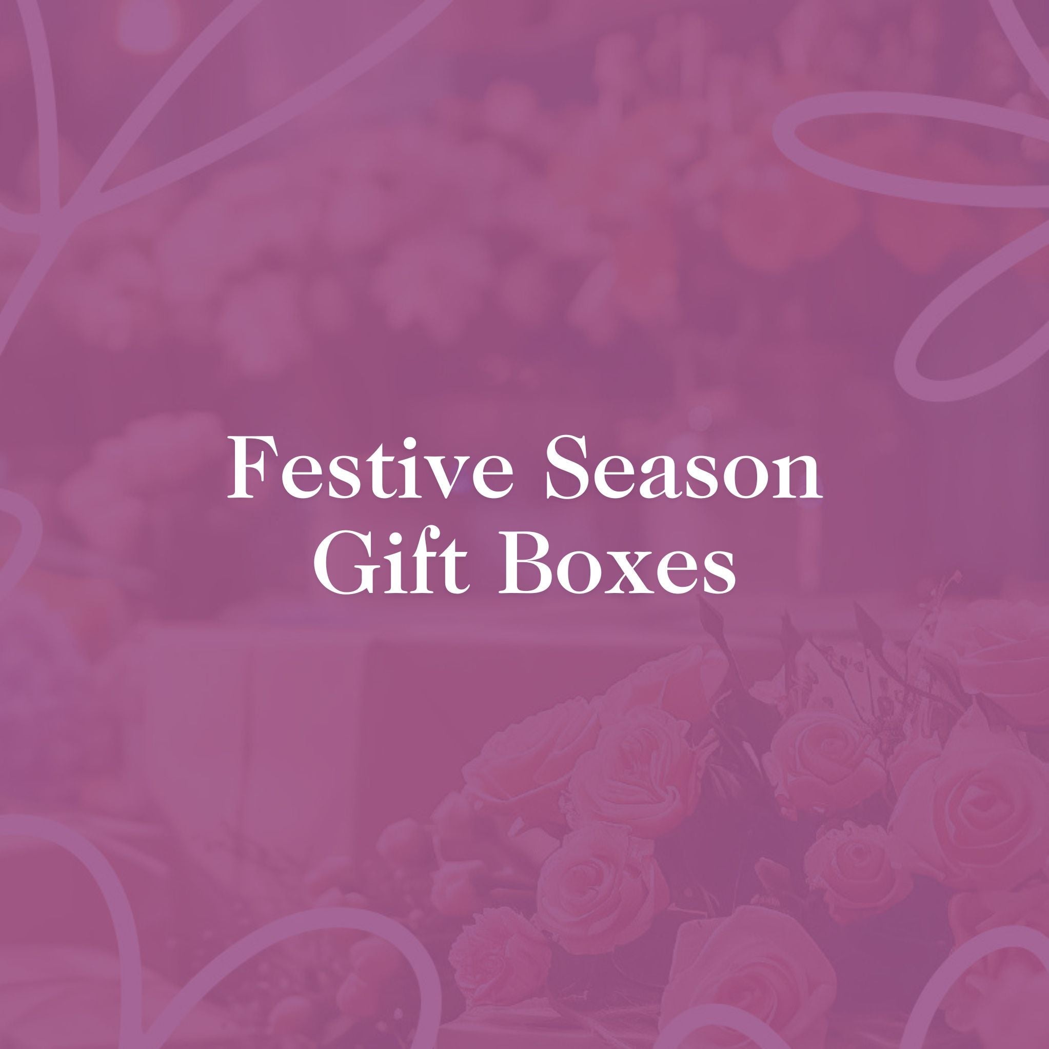 Festive Season Gift Boxes banner with pink floral background and elegant text, promoting Fabulous Flowers and Gifts holiday collection.