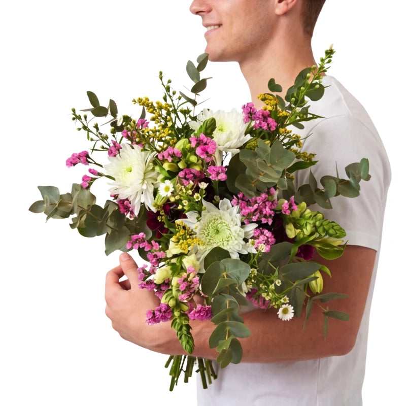 Man holding a bouquet of flowers against a white background