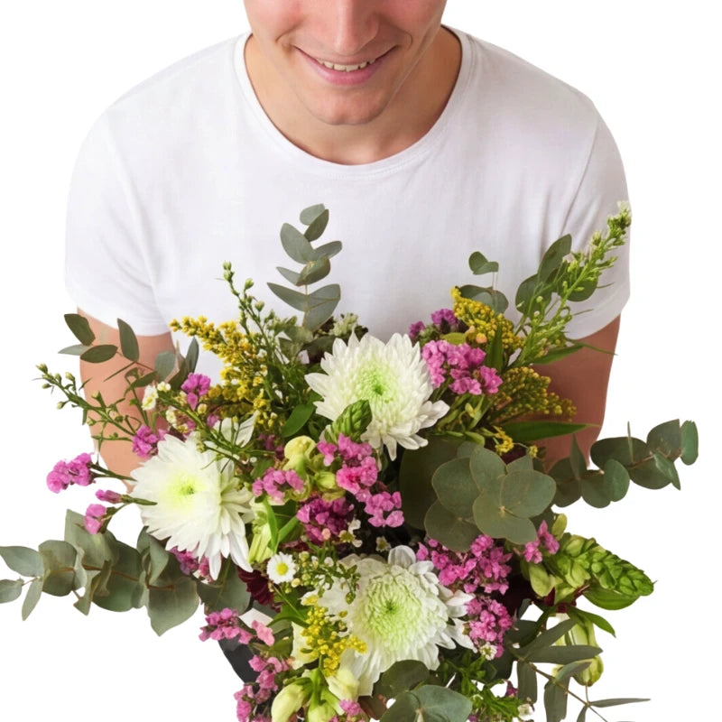 Person holding a bouquet of flowers against a white background