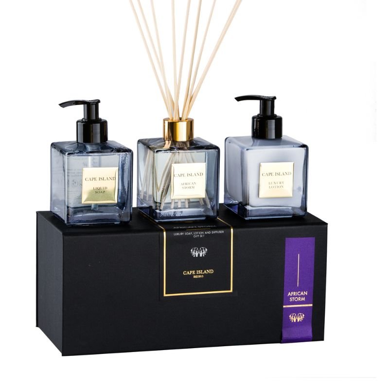 Three diffuser bottles with pump caps on a black stand with 'Cape Island' branding.