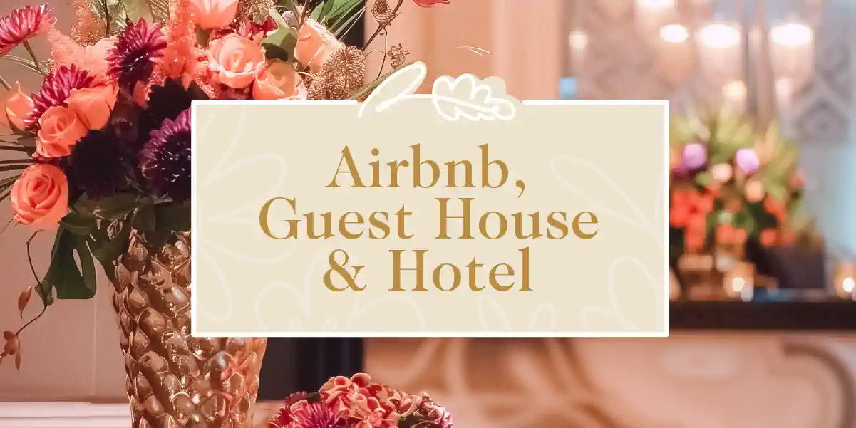 Airbnb, Guest House and Hotel Collection: Luxurious floral arrangement in a gold vase, adding elegance to a reception area. Fabulous Flowers and Gifts.