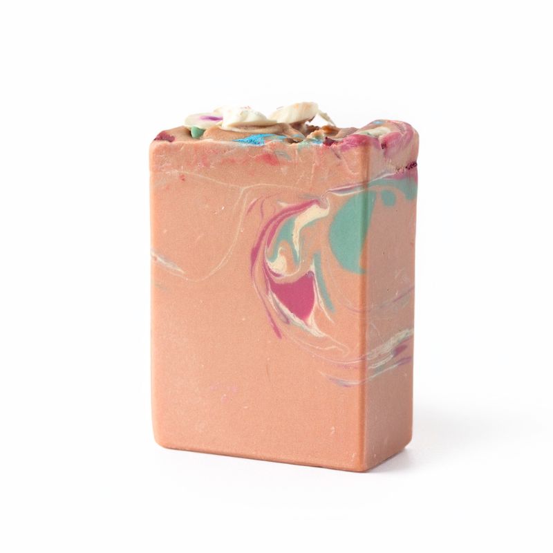 Marbled soap bar with pink, blue, and white colors on a white background