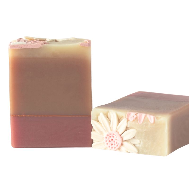 Allemande Soap with marbled swirls of pink, teal, and gold and hand-piped floral detail on side.