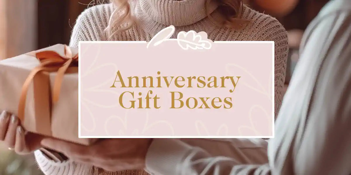Woman receiving a wrapped gift box part of the Anniversary Gift Box collection - Fabulous Flowers and Gifts