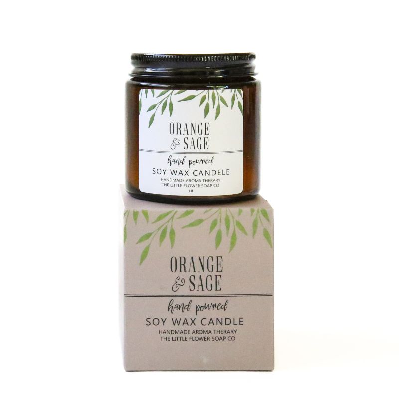 Orange & Sage soy wax candle with packaging on a white background
