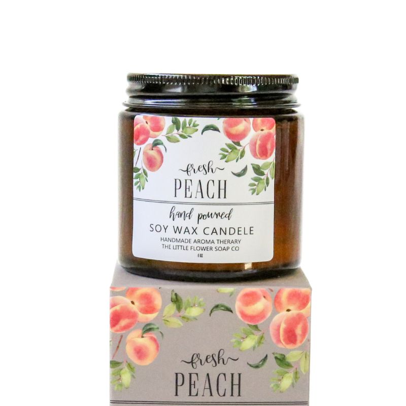 Close-up of Fresh Peach soy wax candle in amber jar with peach label