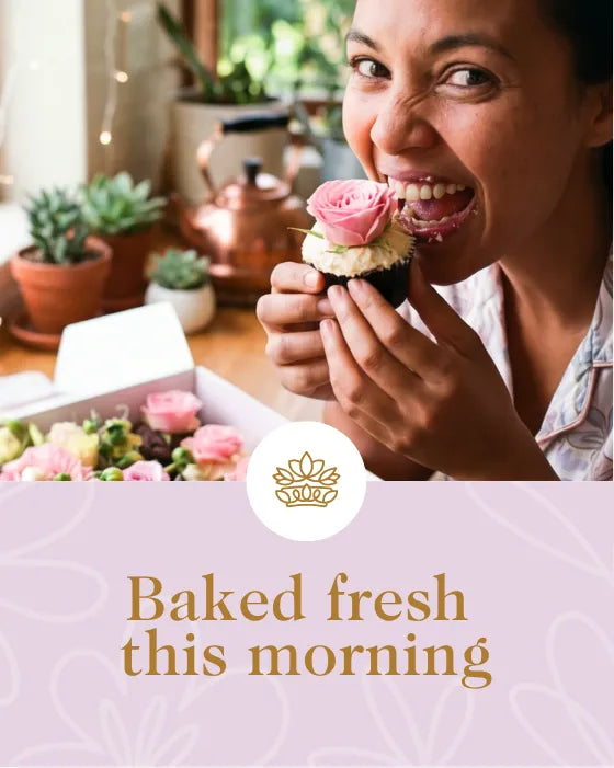Woman eating a cupcake with pink frosting in a kitchen setting, with text 'Baked fresh this morning' and a logo.