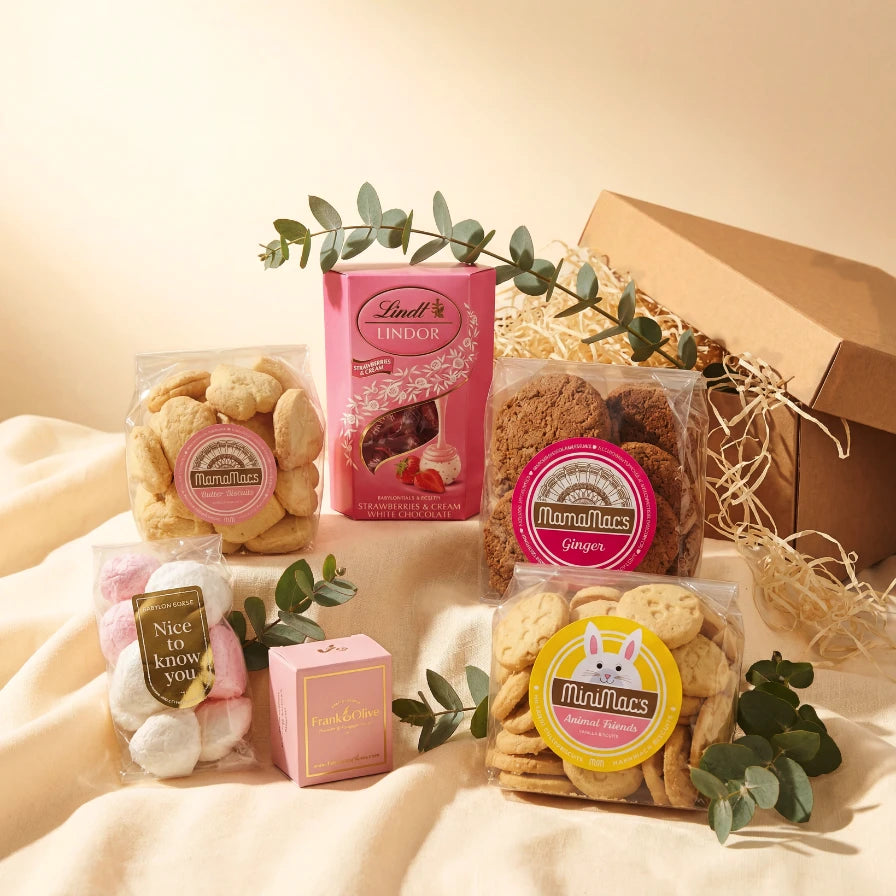 Birthday Treats for Her gift box with MamaMacs butter biscuits, MamaMacs ginger biscuits, MiniMacs animal friends vanilla biscuits, Frank & Olive fudge, Nice to Know You marshmallows and Lindt Lindor Strawberries & Cream white chocolate in a Kraft gift box with eucalyptus