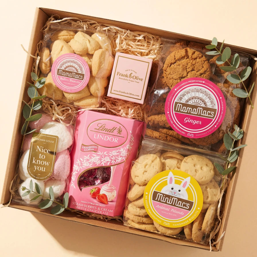 Birthday Treats for Her gift box flat lay with MamaMacs ginger and butter biscuits, MiniMacs vanilla biscuits, Frank & Olive fudge, Nice to Know You marshmallows and pink Lindt Lindor Strawberries & Cream from Fabulous Flowers