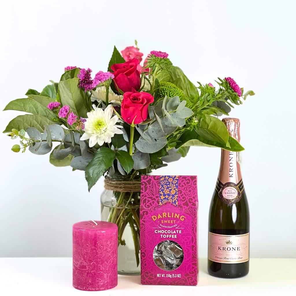 Elegant Bloom & Bubble Flower Set for Special Occasions includes pink candle, pink, white and green flower arrangement and chocolate toffees- Fabulous Flowers and Gifts