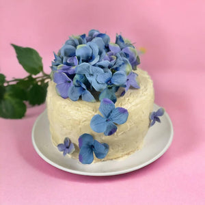 Luxury Madeira cake with faux blue flowers decoration by Fabulous Flowers and Gifts.