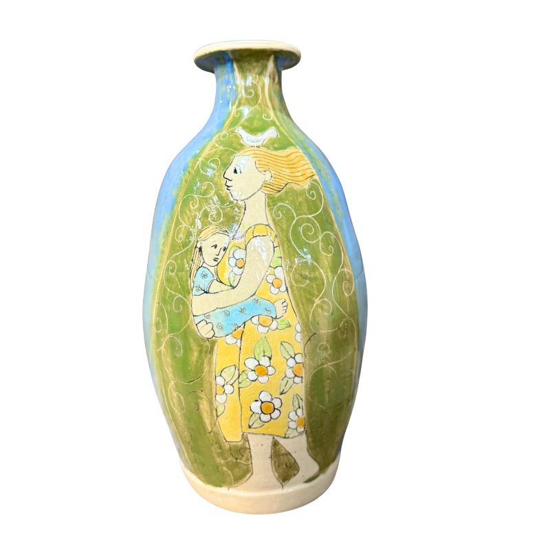 Decorative vase with artistic design of a woman holding a child on a white background