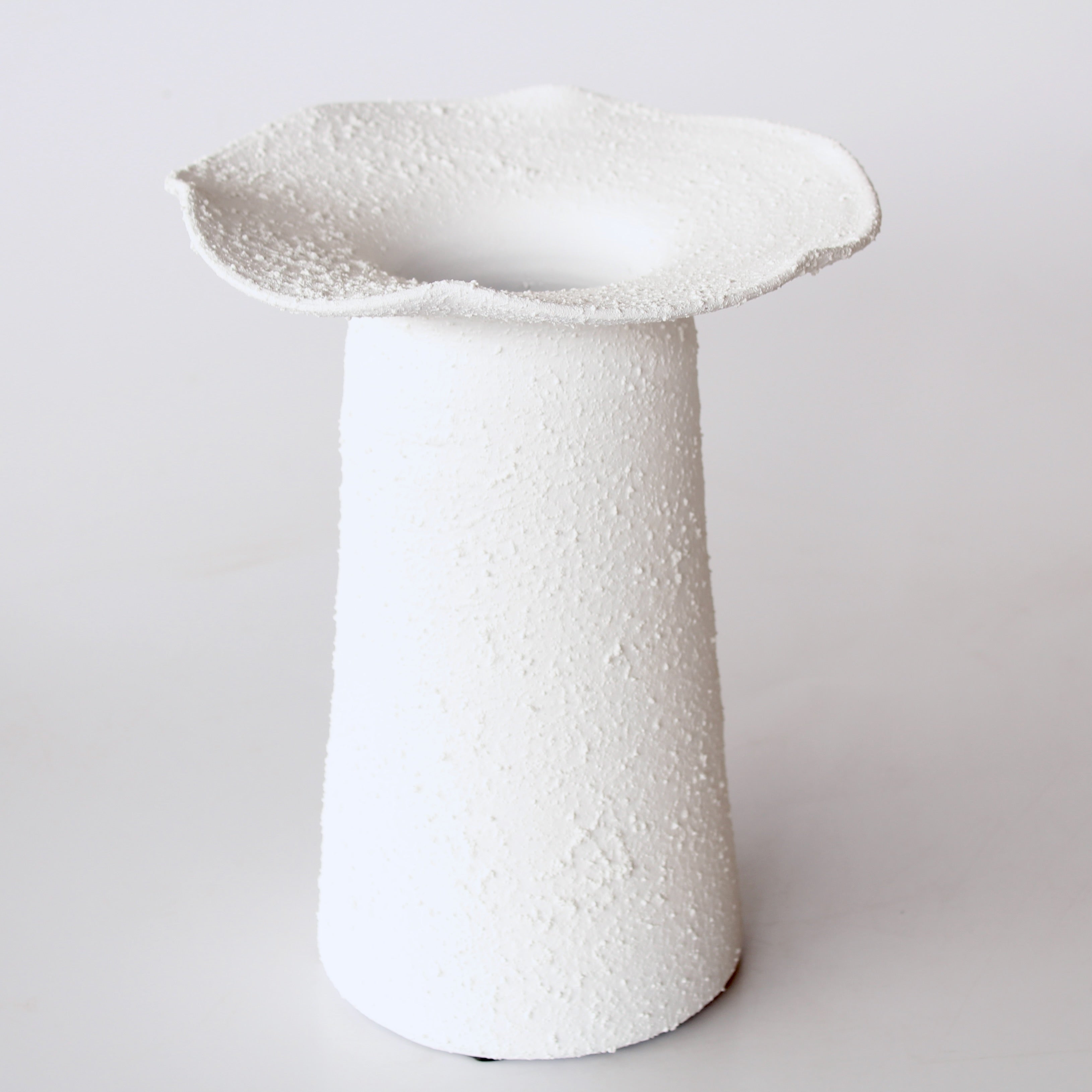 White textured vase on a light gray background