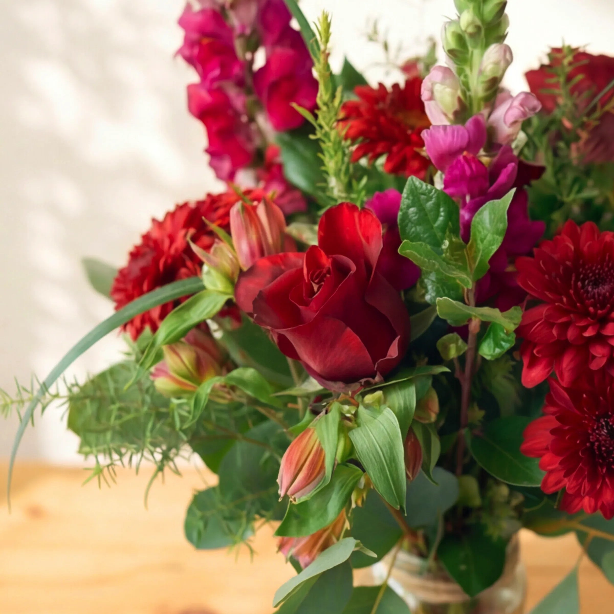 Red roses, chrysanthemums and pink snapdragons in the Charming flower arrangement, same-day Cape Town and Joburg delivery