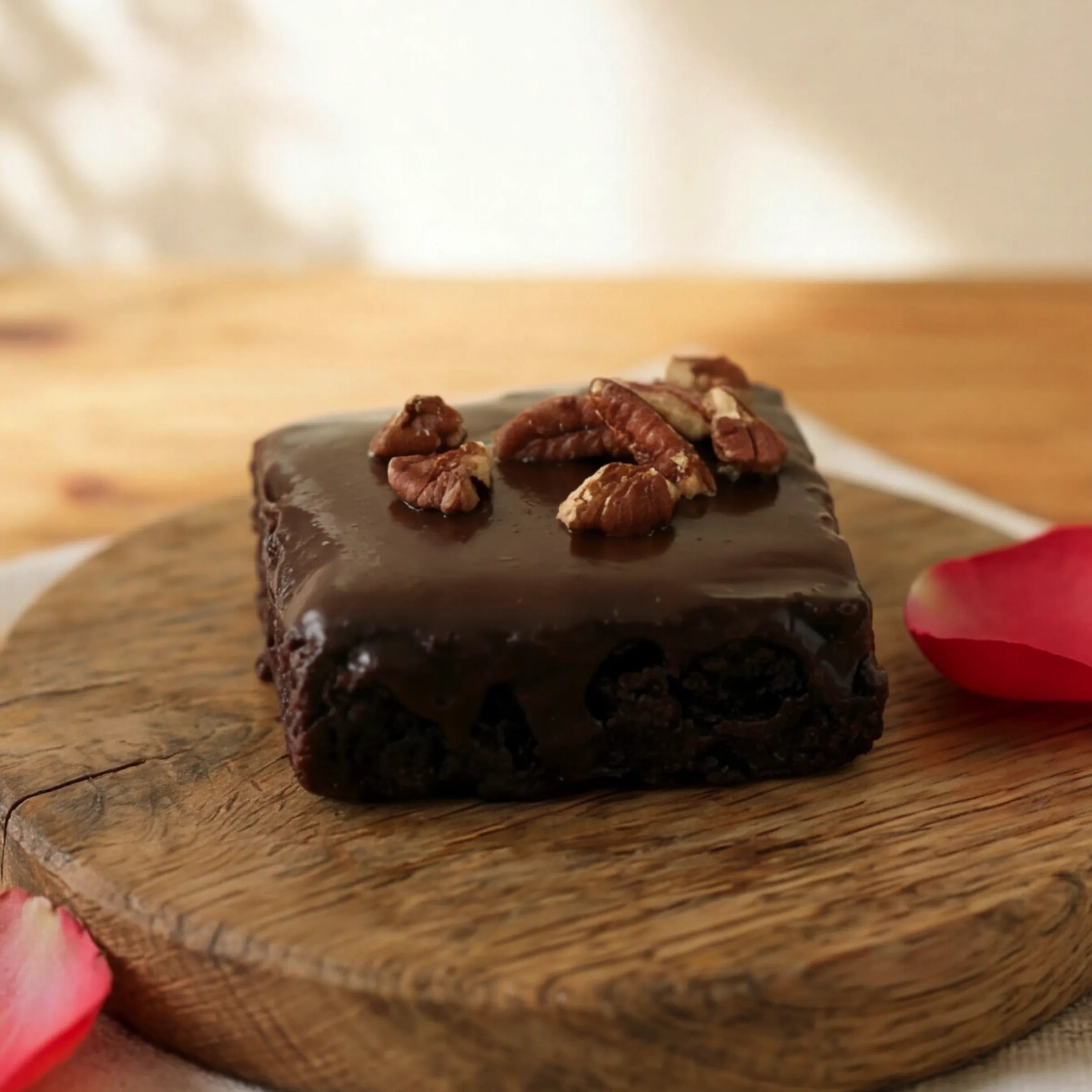 Side view of dense fudgy Chocolate Brownie with chocolate glaze and pecans, hand-made Cape Town since 1999