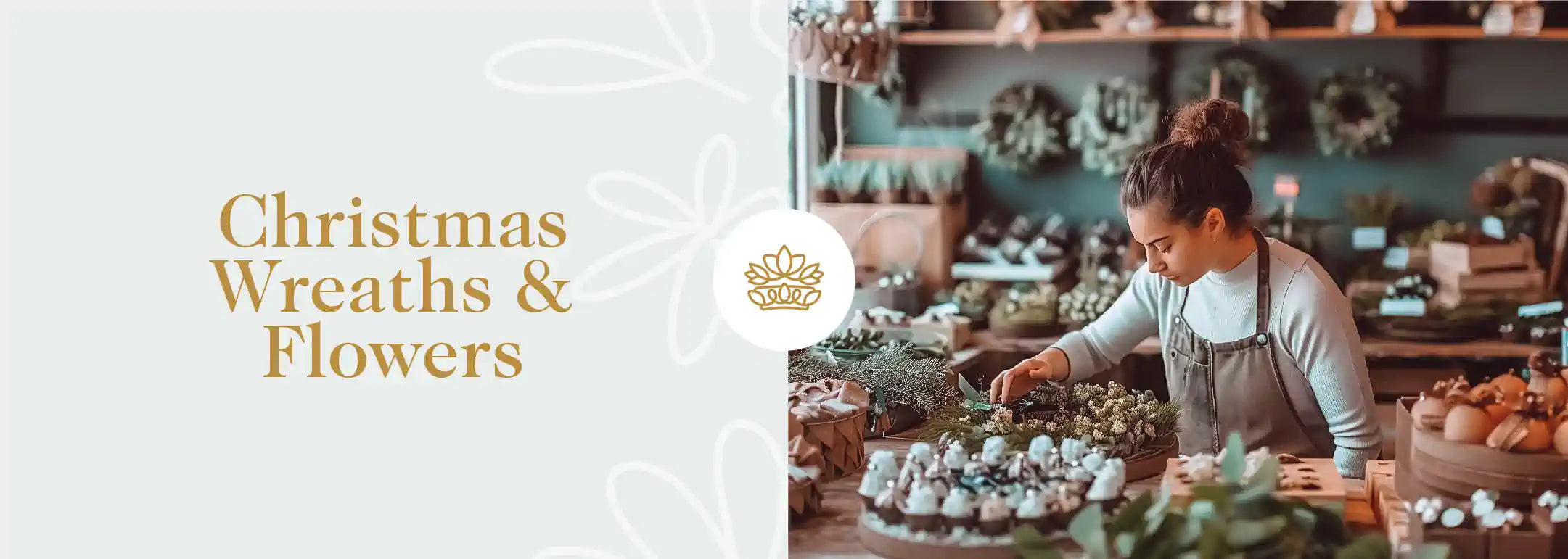 A florist arranging a Christmas wreath surrounded by festive decorations. Fabulous Flowers and Gifts - Christmas Wreaths & Flowers