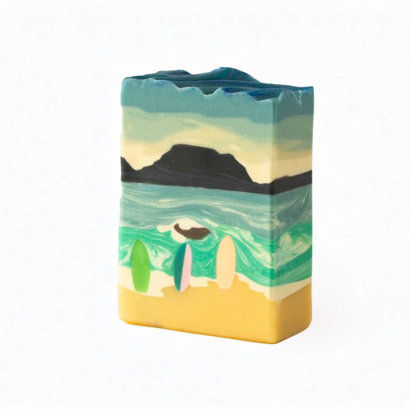 Beach-inspired Citrus Escape artisan soap featuring ocean waves, surfboards, and a coastal sunset scene.