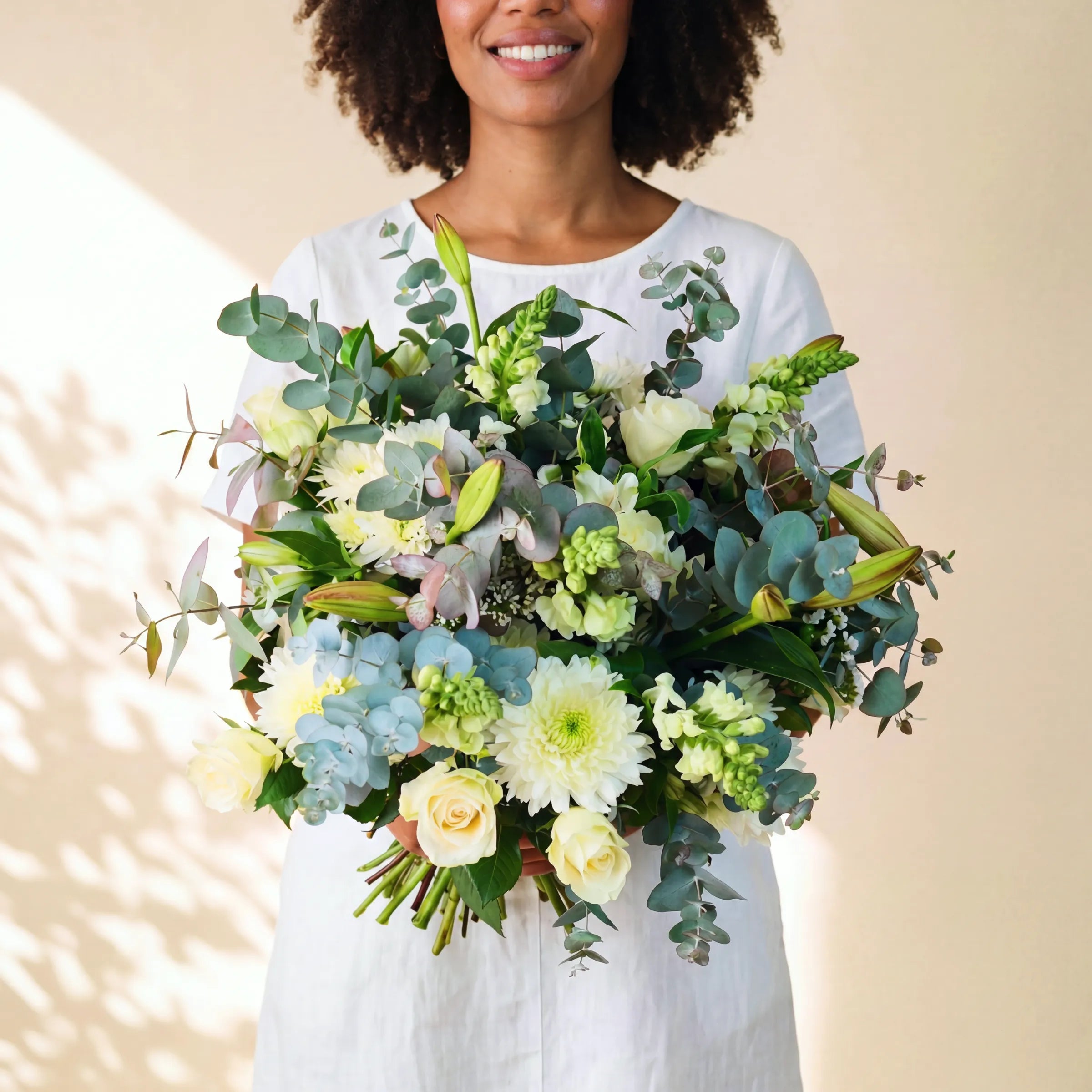Classic White Bouquet ivory roses, white chrysanthemums, pale blue hydrangea and St Joseph lily buds, hand-tied for same-day Cape Town delivery