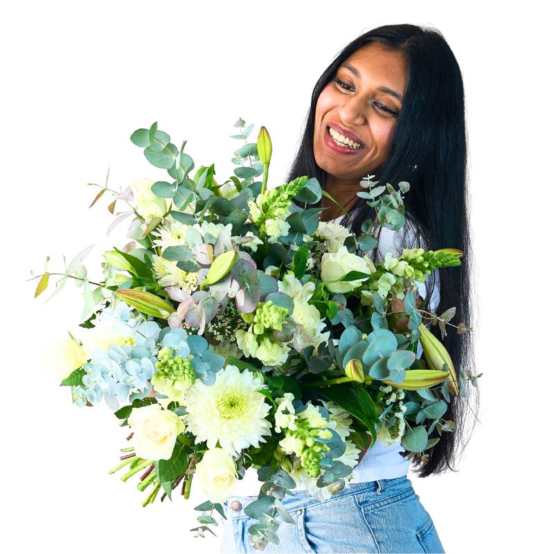 Woman holding a large bouquet of green and white flowers against a white background