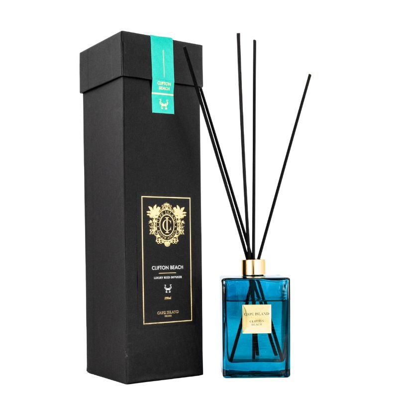 Blue diffuser bottle with black sticks and black box on a white background