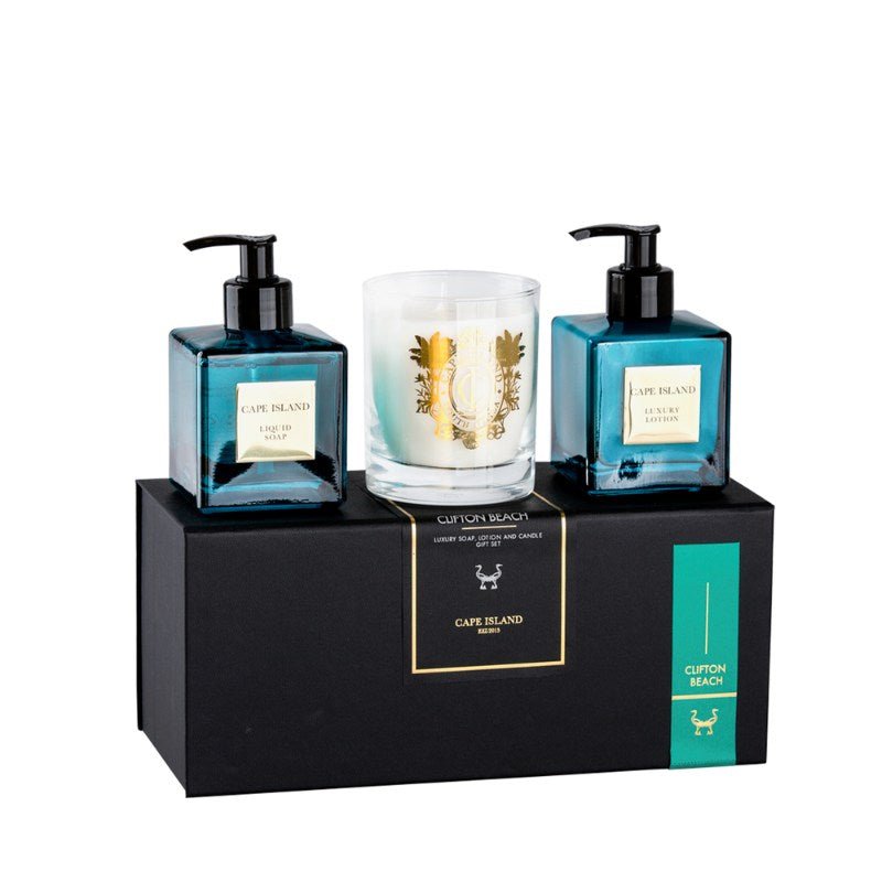 Two blue bottles with black pumps and a white candle on a black stand with 'Cape Island' branding.