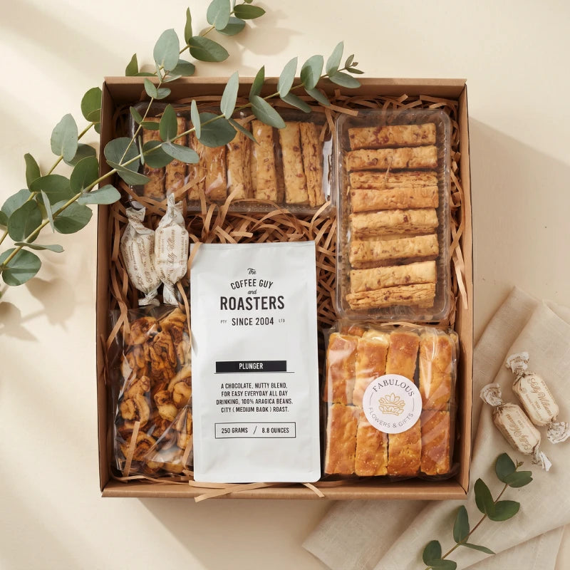 Comfort and Coffee gift flat-lay with The Coffee Guy plunger coffee, cheese straws, FF rusks, Sally Williams nougat and sundried tomatoes, Fabulous Flowers and Gifts