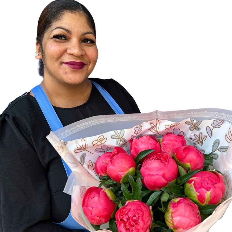 Woman holding a bouquet of pink peony flowers against a white background