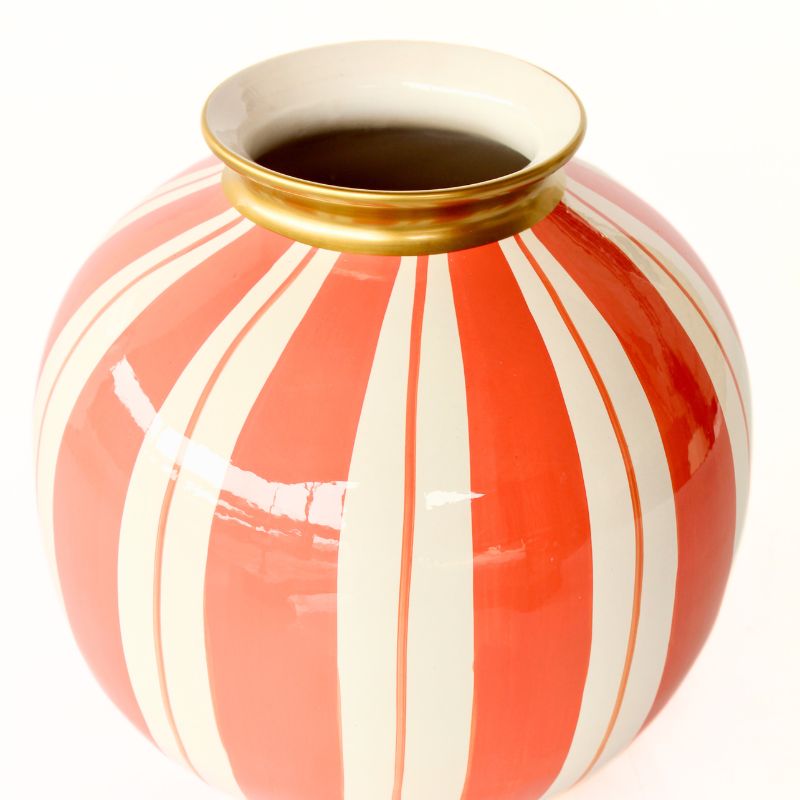 Decorative vase with red and white striped pattern on a white background
