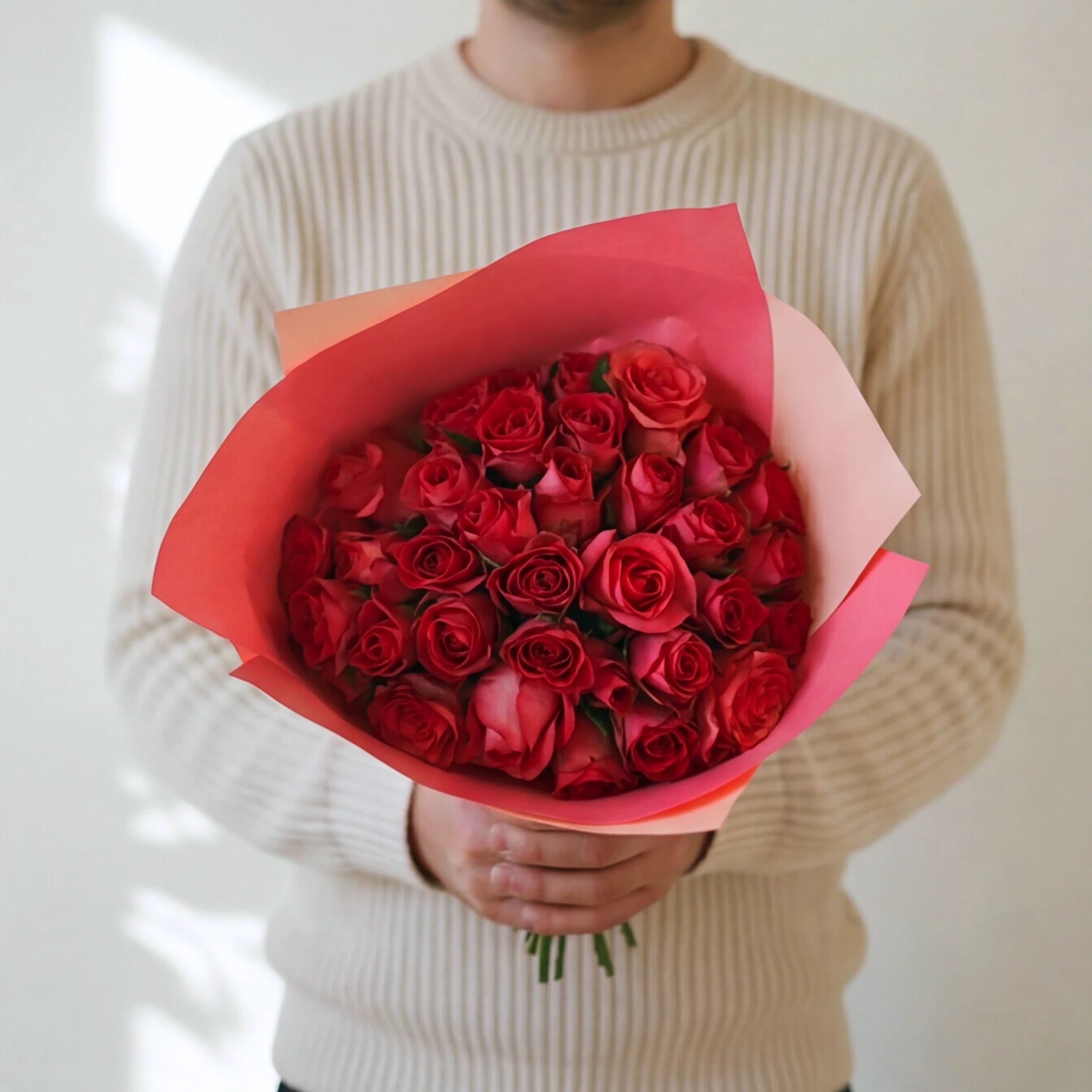The largest Cosmo, three dozen hot pink roses in a two-tone pink wrap, held by a Fabulous Flowers florist