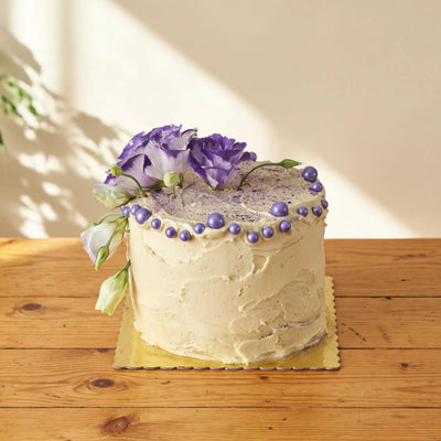 Creamy Violet Dream Cake with bicolour purple lisianthus, purple pearls and dusted top by Fabulous Flowers