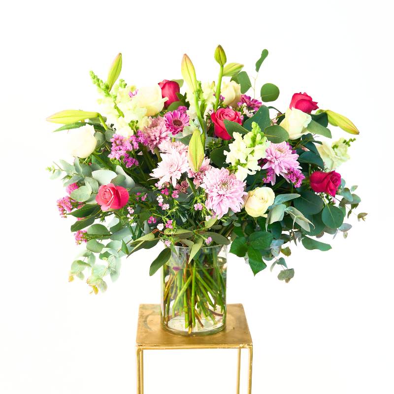 Large flowers in a glass vase on a white background