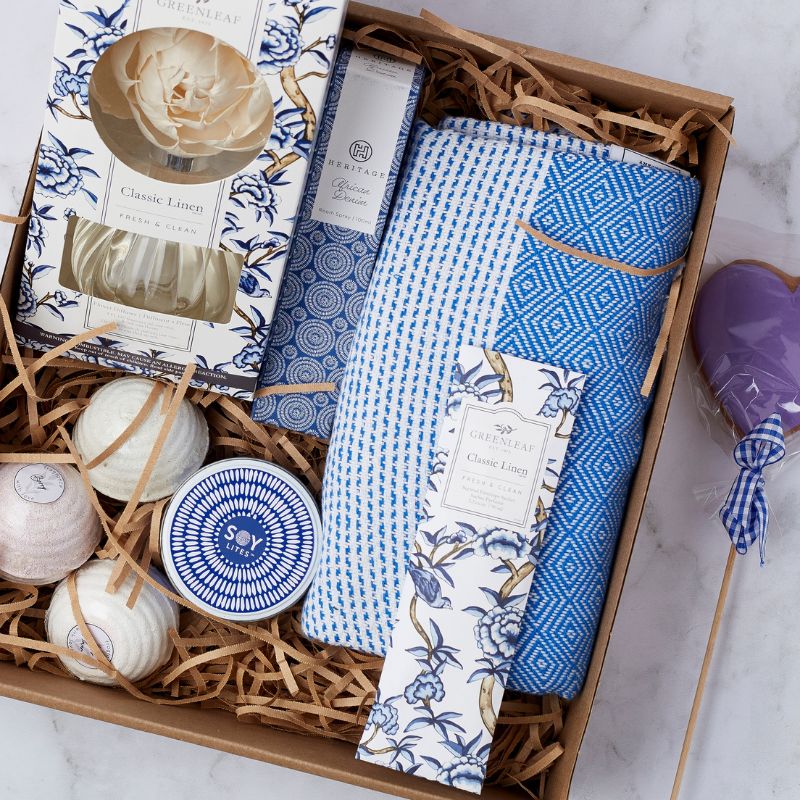 Close-up of Daydream Delight Gift Set including Classic Linen fragrance items, bath products, and purple heart-shaped cookie