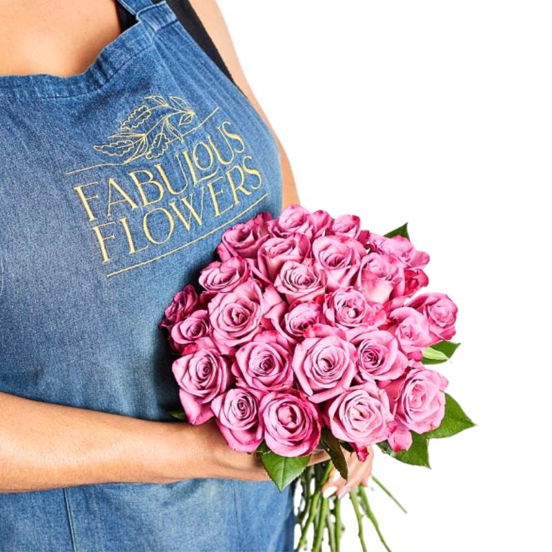 Person holding a bouquet of pink roses wearing a 'Fabulous Flowers' apron.