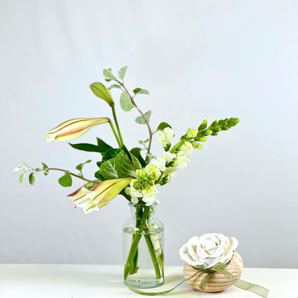 White flowers like st Joseph Lilies, snapdragons, kale in a glass vase with a rose diffuser - Fabulous Flowers