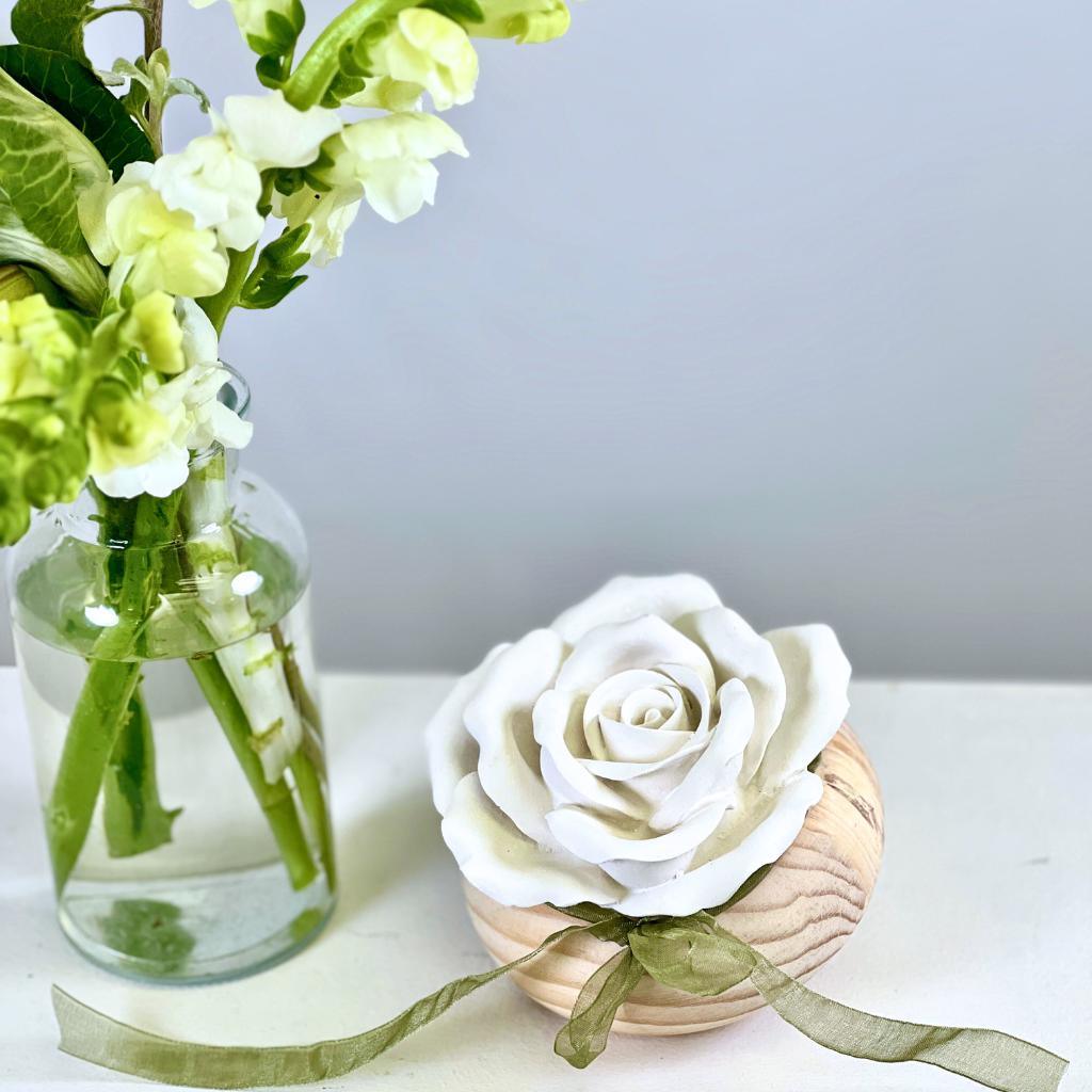 Close up of rose diffuser paired with fresh flower arrangement in a glass vase - Fabulous Flowers