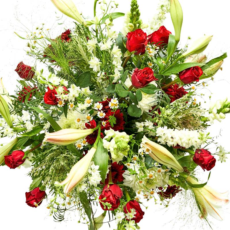 Flower arrangement of red and white flowers with greenery on a white background