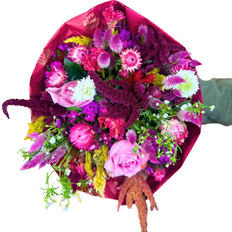Enchanted Garden Flower Bouquet — vibrant pink roses, magenta blooms, celosia and textured statice wrapped in deep berry paper