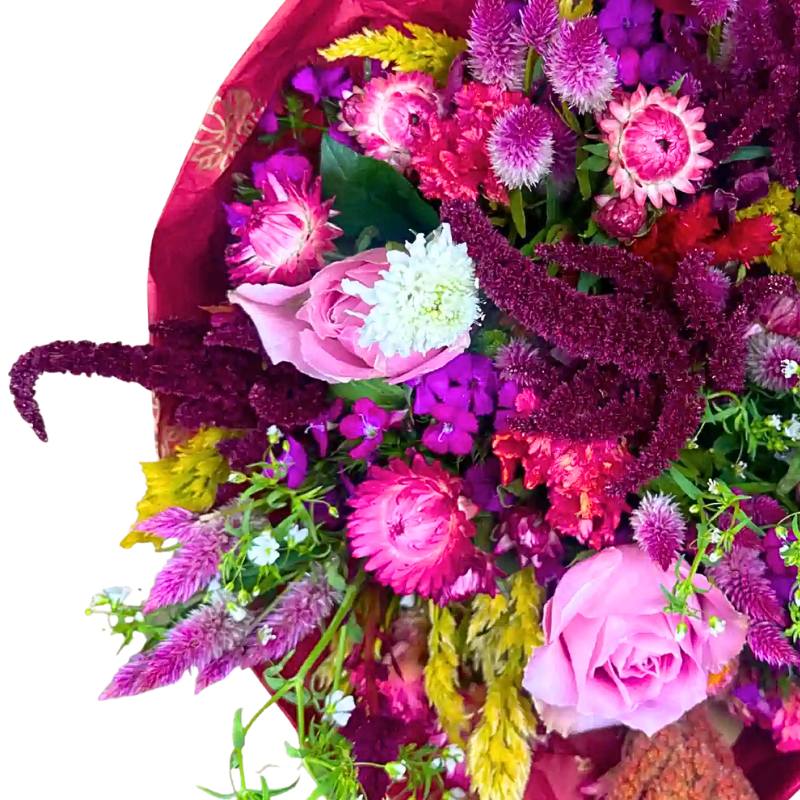 Enchanted Garden Flower Bouquet close-up — pink roses with bright strawflowers, burgundy celosia and purple seasonal blooms