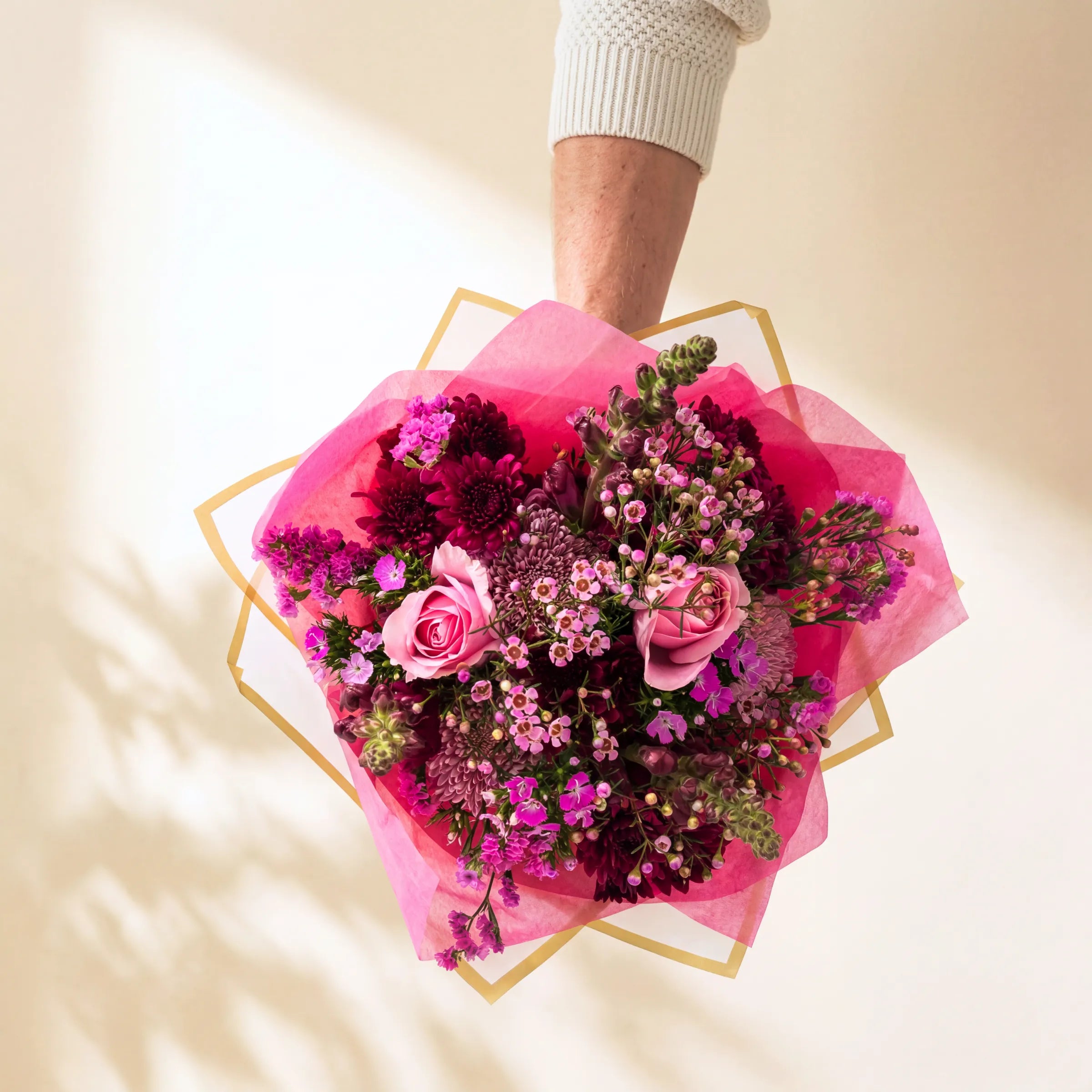 Gift-wrapped pink flower bouquet of roses, burgundy chrysanthemums, dianthus and waxflower from Fabulous Flowers