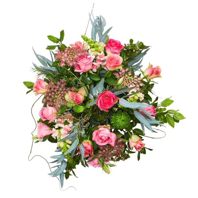 Top shot of arrangement of pink roses and greenery on a white background