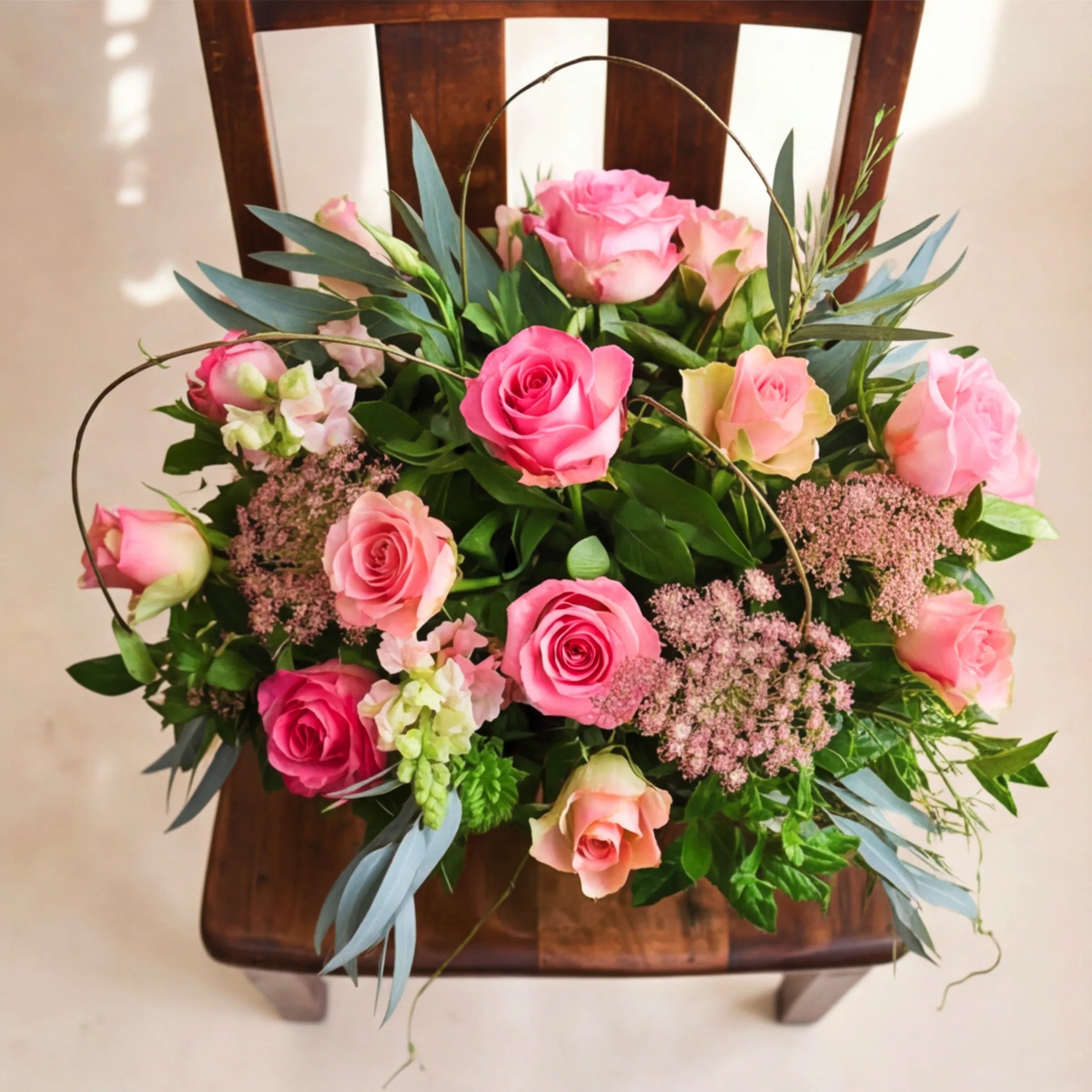 Top-down view of pink rose centrepiece with pink ammi and eucalyptus by Fabulous Flowers Claremont