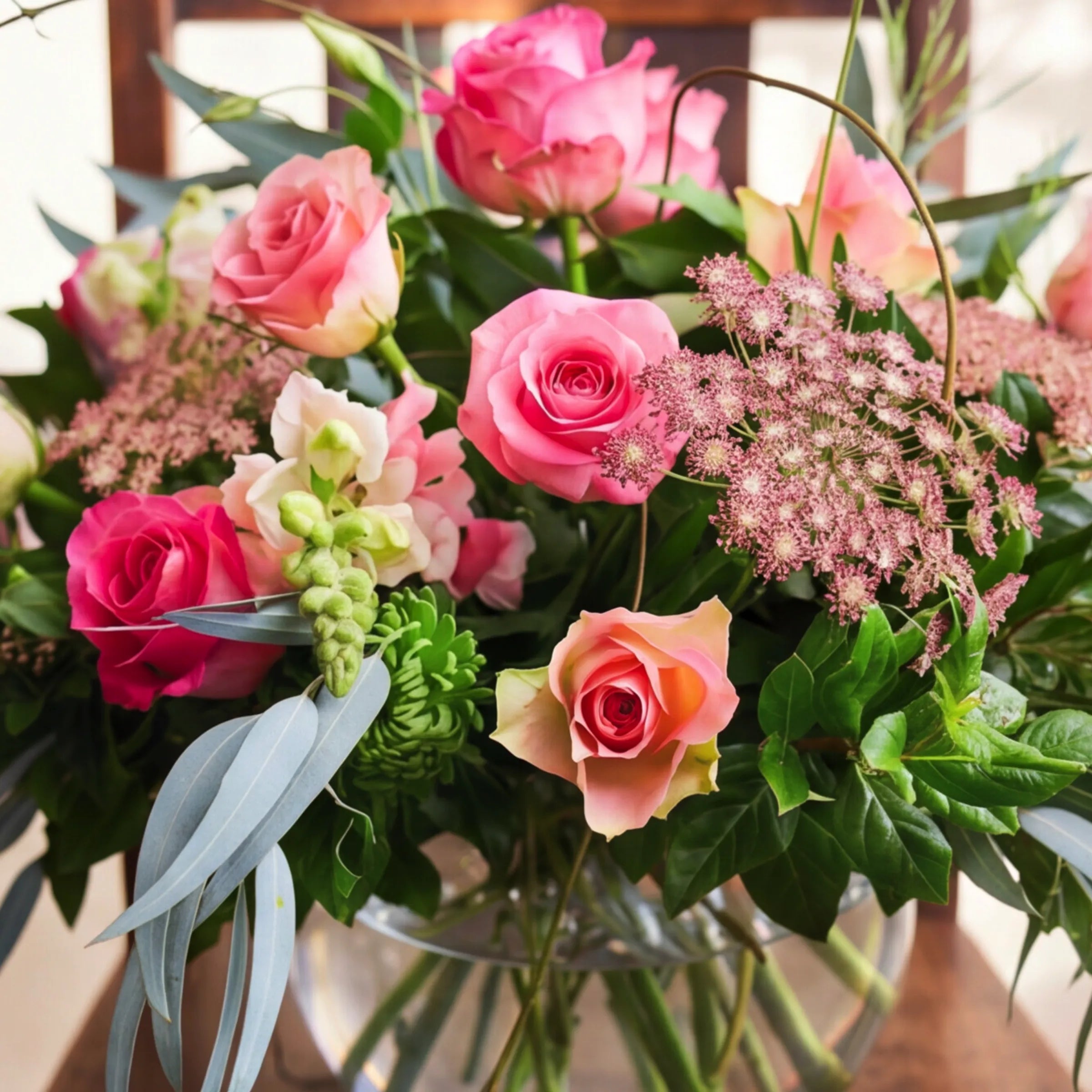 Detail of pink roses, pink ammi and snapdragons in glass fish-bowl by Fabulous Flowers Claremont studio