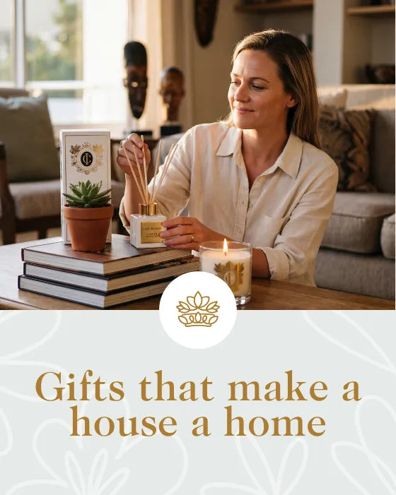 Woman in a cozy living room with decorative items and a candle, promoting gifts for home decor.