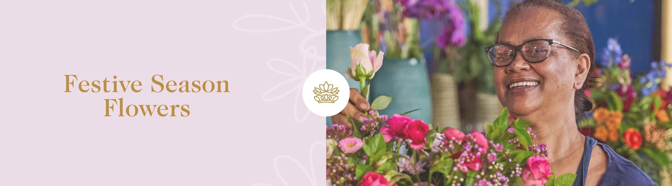 Festive Season Flowers banner for Fabulous Flowers & Gifts, featuring a smiling florist arranging vibrant flowers in a cheerful setting.