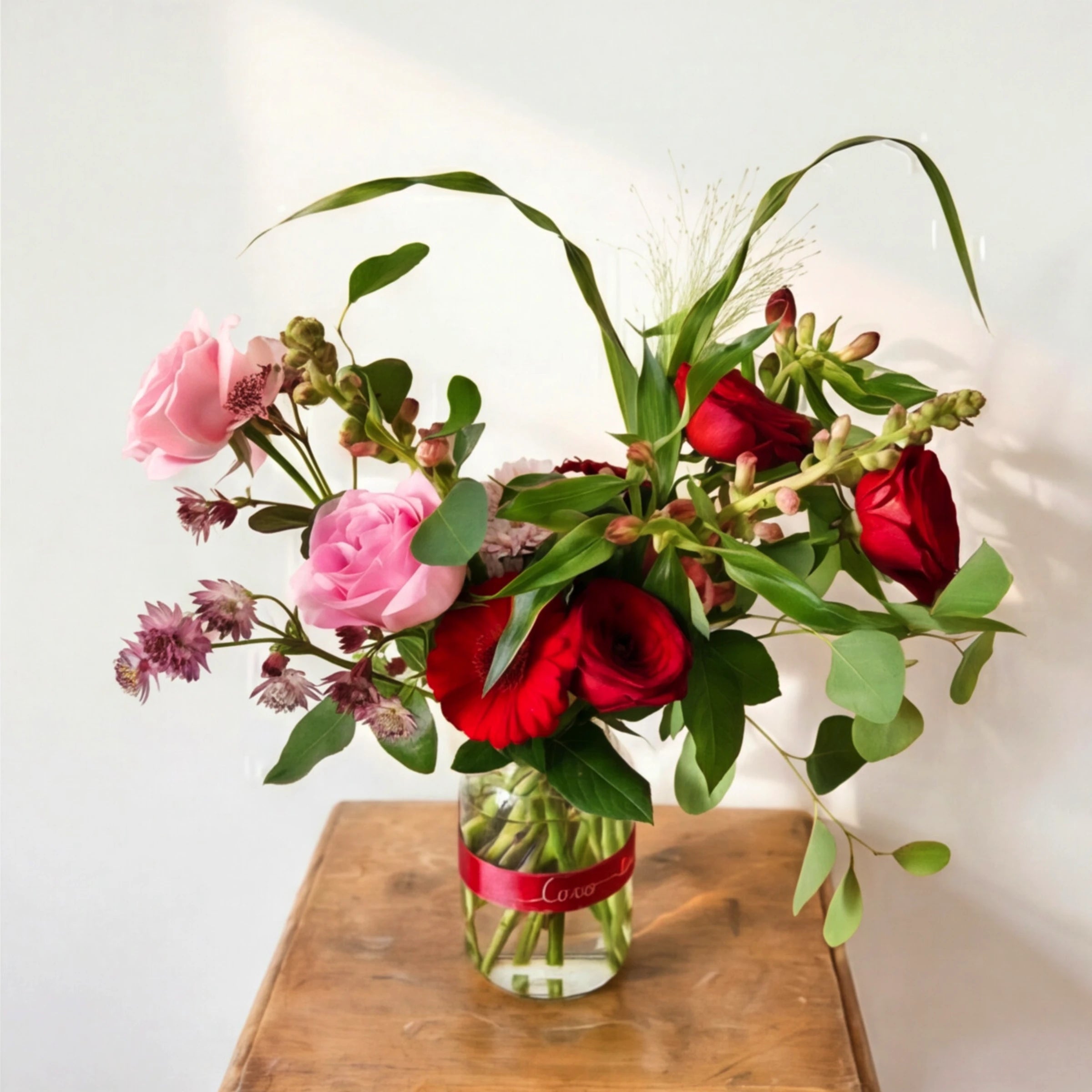 Top view of the Vibrant Rose Bouquet by Fabulous Flowers South Africa, multicoloured red, pink, lilac, orange and yellow roses hand-tied for milestone birthdays and anniversaries