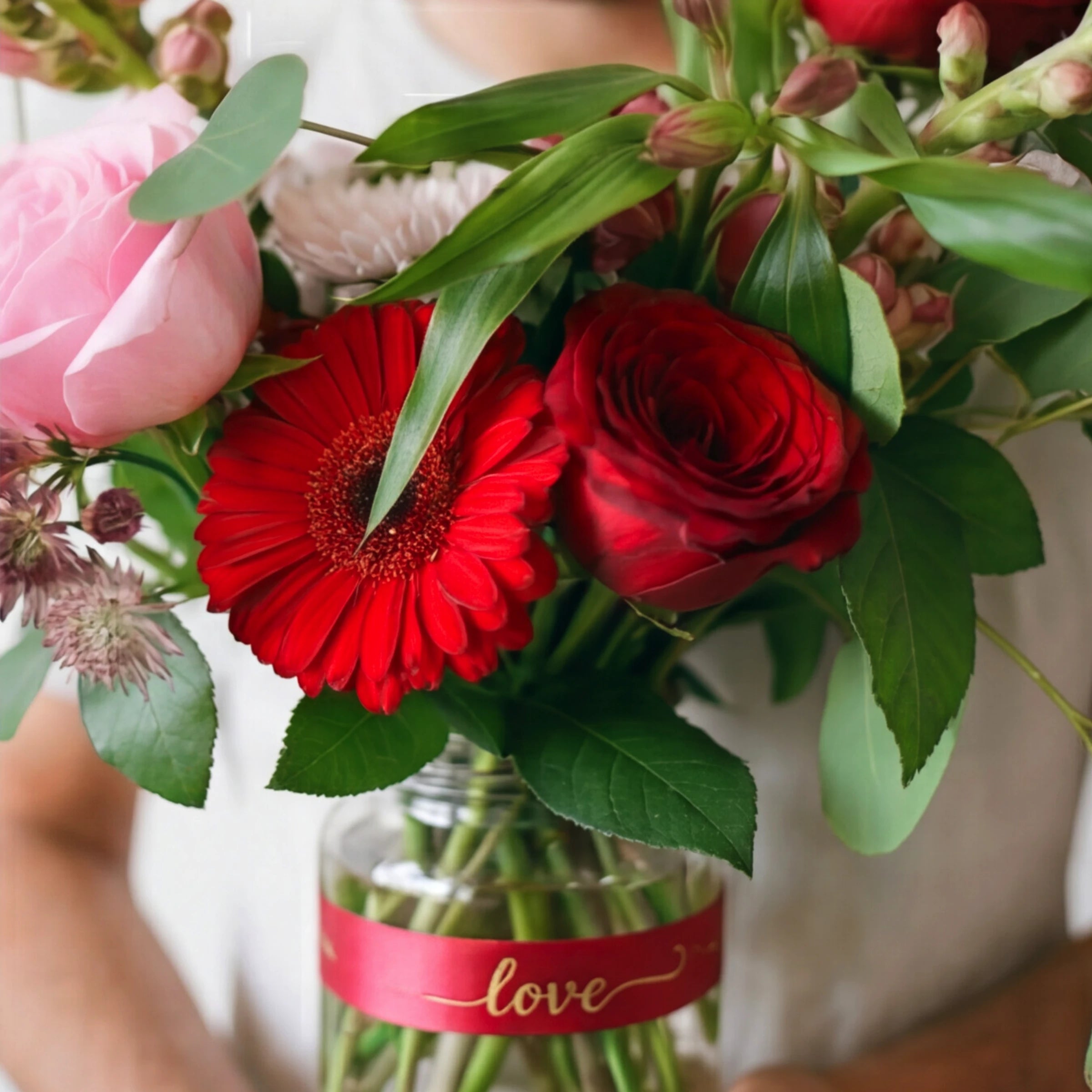 The Vibrant Rose Bouquet from Fabulous Flowers South Africa held against natural light, 45 multicoloured roses in red, pink, lilac and orange for same-day Cape Town flower delivery